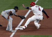 Pittsburgh Pirates third baseman Ke'Bryan Hayes, left, attempts to tag out St. Louis Cardinals' Yadier Molina who steals third base during the third inning of a baseball game Friday, June 25, 2021, in St. Louis. (AP Photo/Joe Puetz)
