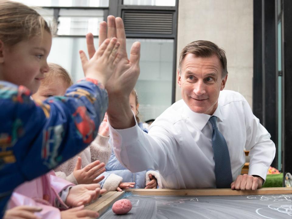 Chancellor Jeremy Hunt during a visit to Busy Bees nursery in Battersea, south London (PA)