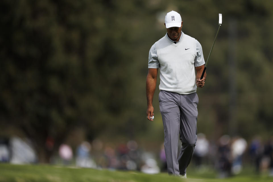 Tiger Woods acknowledges the crowd after making birdie on the 10th hole during the third round of the Genesis Invitational golf tournament at Riviera Country Club, Saturday, Feb. 18, 2023, in the Pacific Palisades area of Los Angeles. (AP Photo/Ryan Kang)