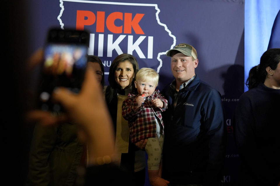 Republican presidential candidate former UN Ambassador Nikki Haley, left, poses for a photo with audience members at a campaign event at Jethro's BBQ in Ames, Iowa, Sunday, Jan. 14, 2024. (AP Photo/Carolyn Kaster)