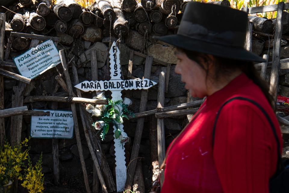 A relative mourns by a mass grave from where the remains of the victims of the 1985 Accomarca massacre were recovered, in Lloqllapampa-Accomarca, Ayacucho department, southern Peru, on May 19, 2022.  / Credit: ERNESTO BENAVIDES/AFP via Getty Images