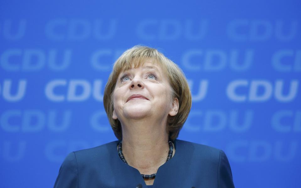 German Chancellor and leader of the Christian Democratic Union ( CDU) Angela Merkel, smiles during a news conference after a CDU party board meeting in Berlin September 23, 2013, the day after the general election. Merkel faces the daunting prospect of persuading her centre-left rivals to keep her in power after her conservatives notched up their best election result in more than two decades but fell short of an absolute majority. (REUTERS/Kai Pfaffenbach)