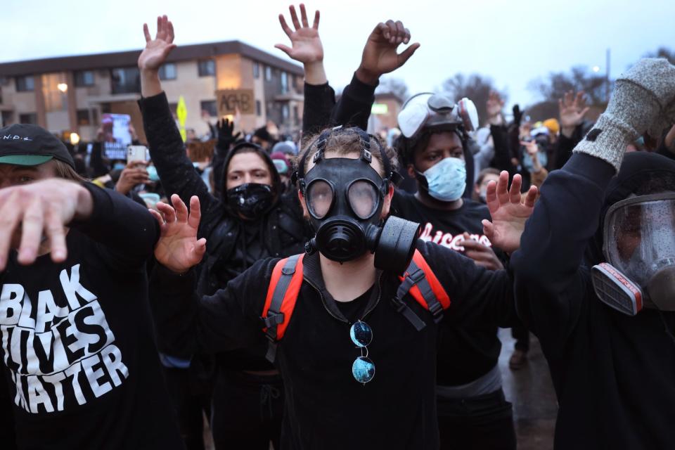 Demonstrators face off with police outside of the Brooklyn Center police station