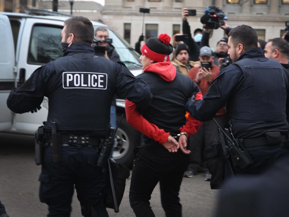 A demonstrator is arrested outside of the Kenosha County Courthouse as the jury deliberates in the trial of Kyle Rittenhouse on November 17, 2021.