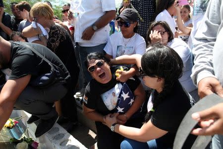 Lucyvette Padro (C) accompanied by family and friends attends the funeral of her son Angel Candelario, one of the victims of the shooting at the Pulse night club in Orlando, at his hometown of Guanica, Puerto Rico, June 18, 2016. REUTERS/Alvin Baez