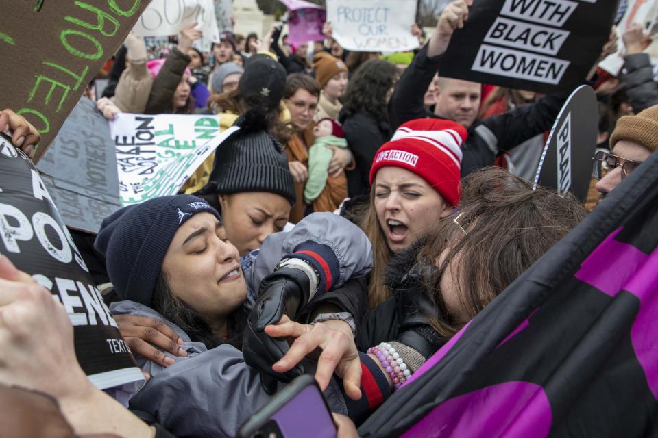 An abortion rights demonstrators and an anti-abortion demonstrator face off in front of the Supreme Court during the Women's March, which largely focused on abortion rights, in Washington, Sunday, Jan. 22, 2023. (AP Photo/Amanda Andrade-Rhoades)