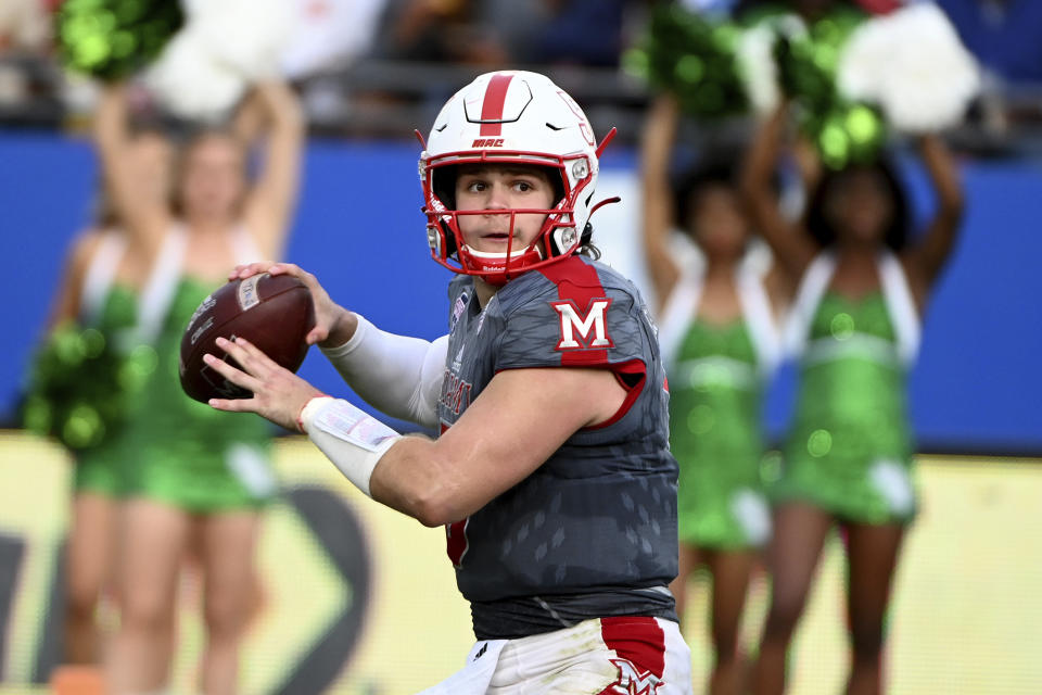 FILE -Miami (Ohio) quarterback Brett Gabbert looks for a receiver during the second half of the team's Frisco Football Classic NCAA college football game against North Texas in Frisco, Texas, Thursday, Dec. 23, 2021. Miami (Ohio) is picked to win the East, largely because of quarterback Brett Gabbert and receiver Mac Hippenhammer, third team all-conference selections last year. Gabbert is the younger brother of NFL quarterback Blaine Gabbert, but the defense needs to be reconstructed. (AP Photo/Matt Strasen, File)