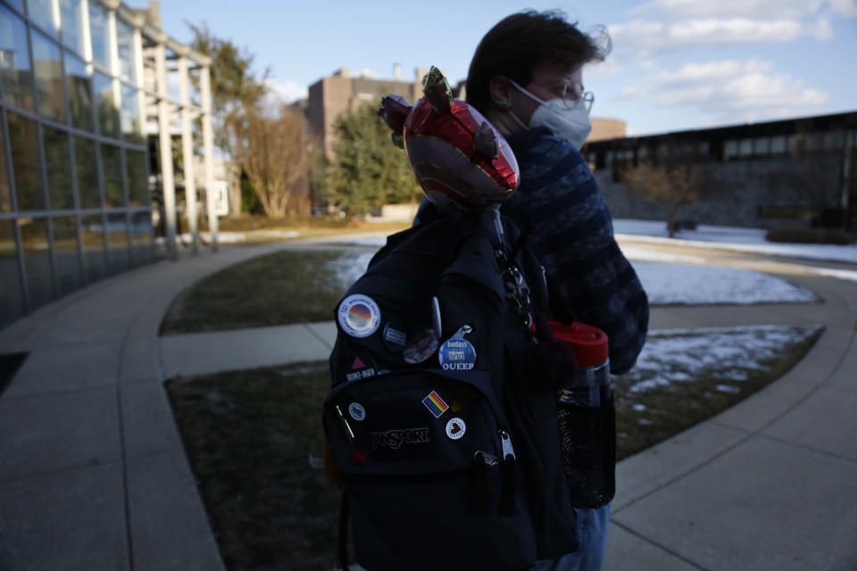 Eli Musselman walks through the campus of St. Joseph's University in Philadelphia sporting queer pride pins on his backpack on Monday, Feb. 14, 2022. Eli, a freshman, came out as transgender almost four years ago and has found support from friends and professors at the university. (AP Photo/Jessie Wardarski)