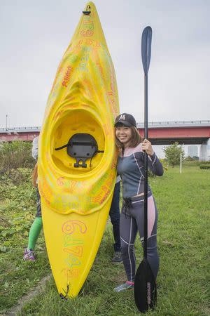 Japanese artist Megumi Igarashi, known as Rokudenashiko, poses with her kayak modeled on her vagina at the Tama river in Tokyo in this October 19, 2013 picture provided by Eigo Shimojo. Igarashi, who made figures of Lady Gaga and the kayak, said on July 16, 2014 from jail she was "outraged" by her arrest and vowed a court fight against obscenity charges. Igarashi, 42, says she was challenging a culture of "discrimination" against discussion of the vagina in Japanese society. Picture taken October 19, 2013. REUTERS/Eigo Shimojo/Handout via Reuters