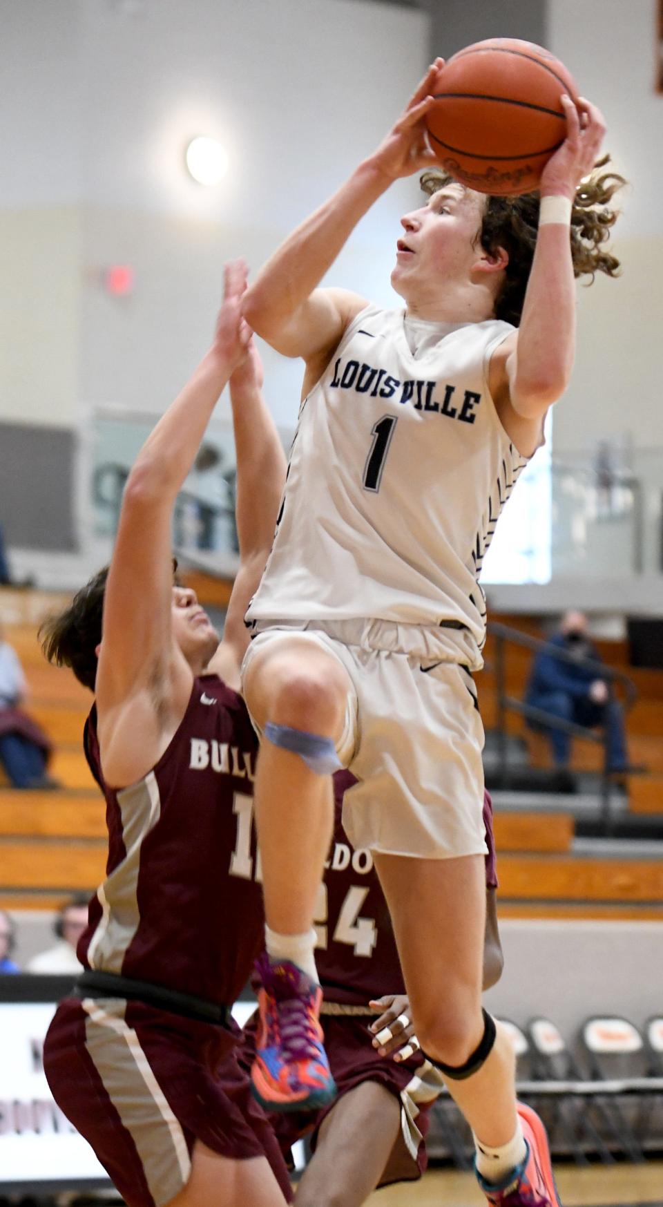 Louisville's Will Aljancic (1) puts up a shot over Woodridge's Benjamin Kiser during the Spectrum Orthopaedics Classic at North Canton Hoover High School on Saturday, Jan. 15, 2022.