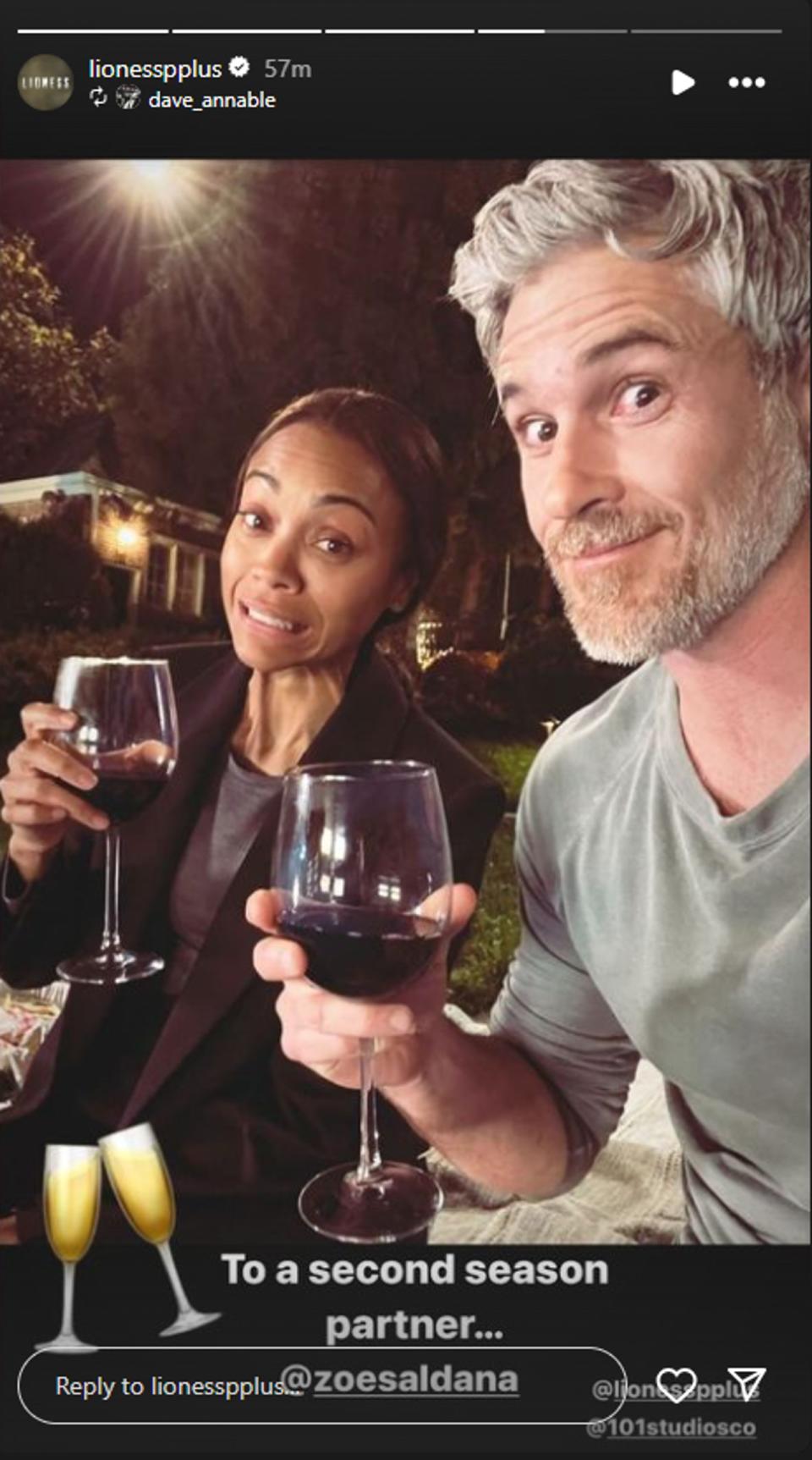 Dave Annable and Zoe Saldana holding up wine glasses saying 