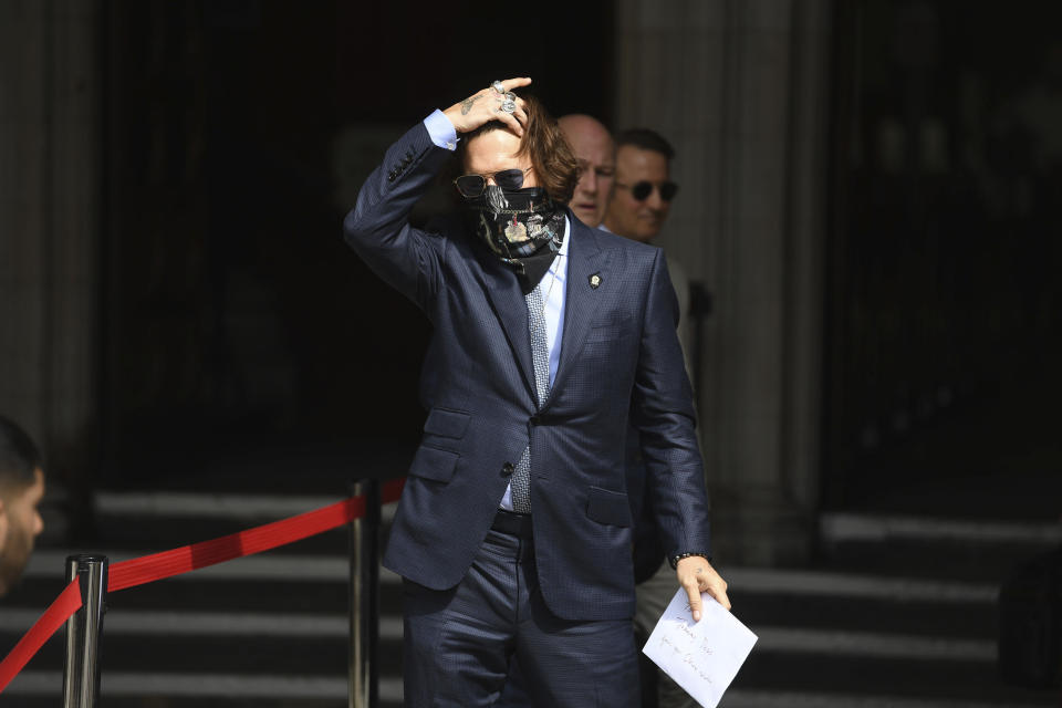 Actor Johnny Depp arrives at the High Court for a hearing in his libel case, in London, Friday, July 24, 2020. Depp is suing News Group Newspapers, publisher of The Sun, and the paper's executive editor, Dan Wootton, over an April 2018 article that called him a "wife-beater." The Sun's defense relies on a total of 14 allegations by his ex-wife, actress Amber Heard of Depp's violence. He strongly denies all of them. (Kirsty O'Connor/PA via AP)