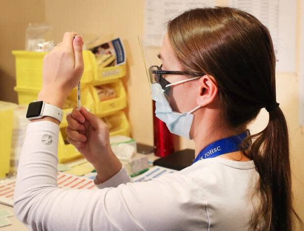 Allison Milley, a nurse at the IWK Health Centre, prepares a COVID-19 vaccine for the first seniors group to be vaccinated in a community-based clinic in Nova Scotia, on Feb. 22, 2021. (Communications Nova Scotia - image credit)