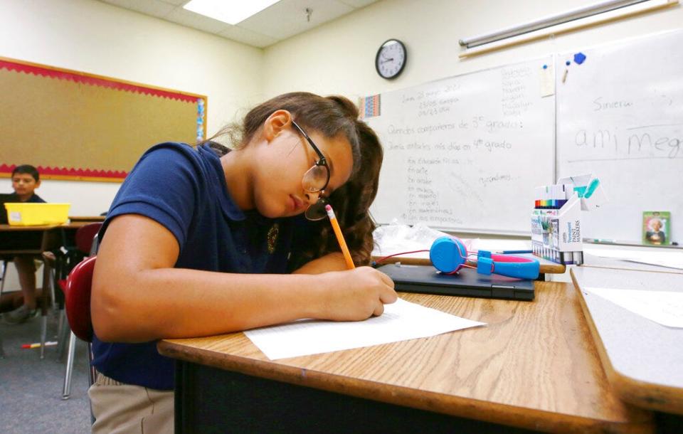 Fourth grade Spanish/English dual language class student Jaqueline Powell, 10, writes her assignment in Spanish at the New Mexico International School in Albuquerque, N.M., on Monday, May 23, 2022.