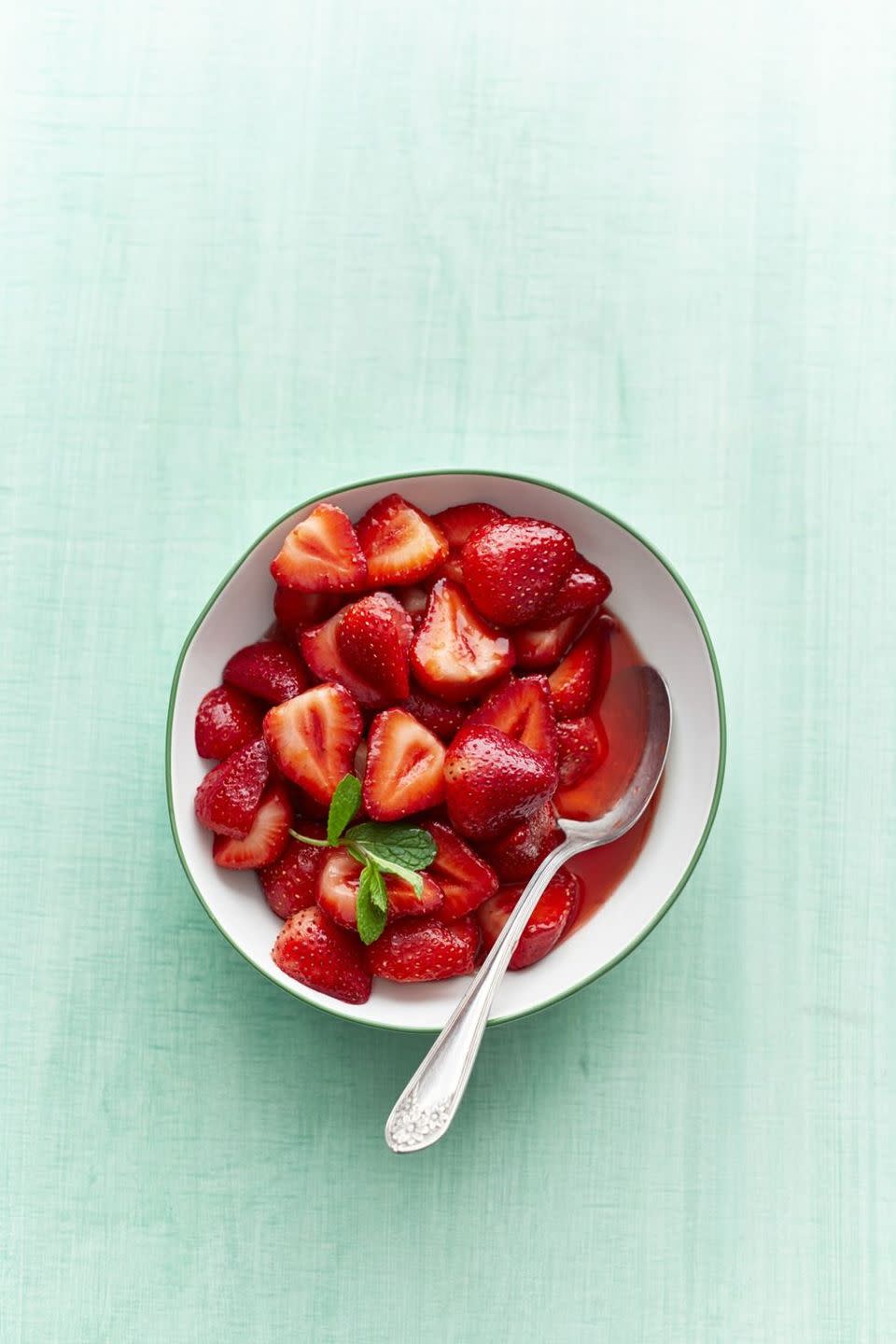 sweet strawberries in bowl with spoon