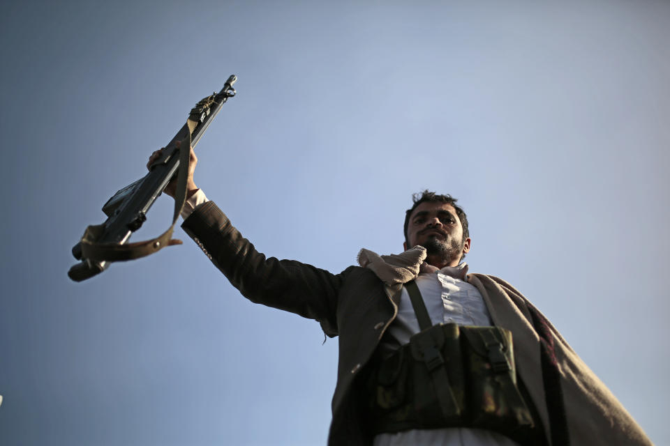 A Houthi supporter holds his weapon during a demonstration against the United States over its decision to designate the Houthis a foreign terrorist organization in Sanaa, Yemen, Monday, Jan. 25, 2021. (AP Photo/Hani Mohammed)