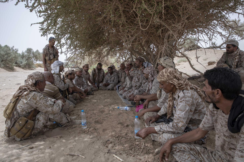 FILE - Yemeni fighters backed by the Saudi-led coalition gather near the front lines near Marib, Yemen, on June 19, 2021. The United Nations is predicting that a record 274 million people – who together would amount to the world’s fourth most-populous country – will require emergency humanitarian aid next year in countries including Afghanistan, Ethiopia, Myanmar, Syria and Yemen as they face a raft of challenges such as war, insecurity, hunger, climate change and the coronavirus pandemic. (AP Photo/Nariman El-Mofty)