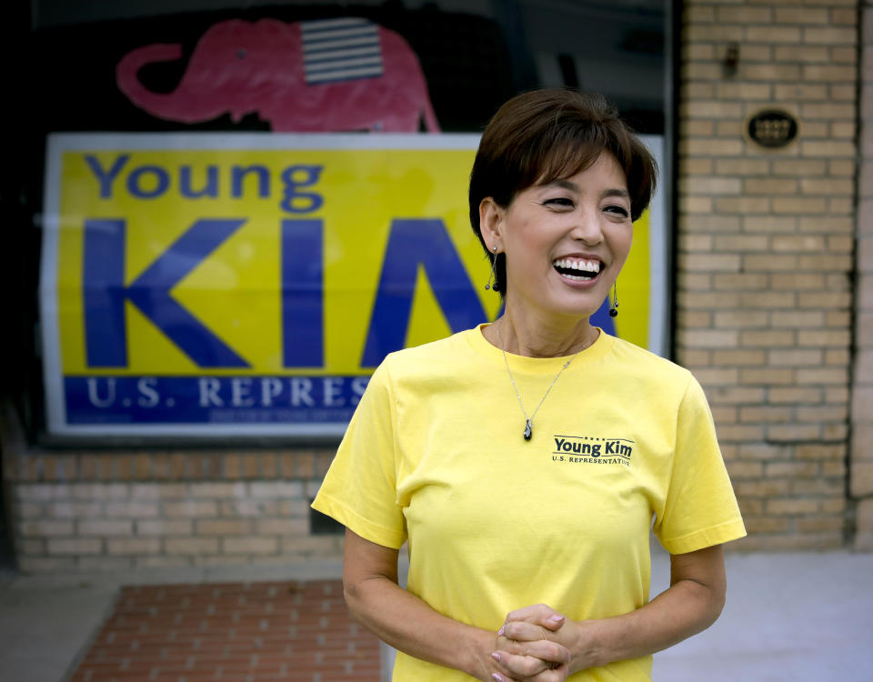 FILE - In this Saturday, Oct. 6, 2018, file photo Young Kim, a candidate who is running for a U.S. House seat in the 39th District in California, smiles outside her campaign office in Yorba Linda, Calif. The South Korean immigrant and former state legislator said she will run in the 40th District, which has a Republican tilt and was vacated by Democratic Rep. Katie Porter, a progressive who jumped to the neighboring contest where the number of Democratic and Republican voters is nearly equal. (AP Photo/Chris Carlson, File)