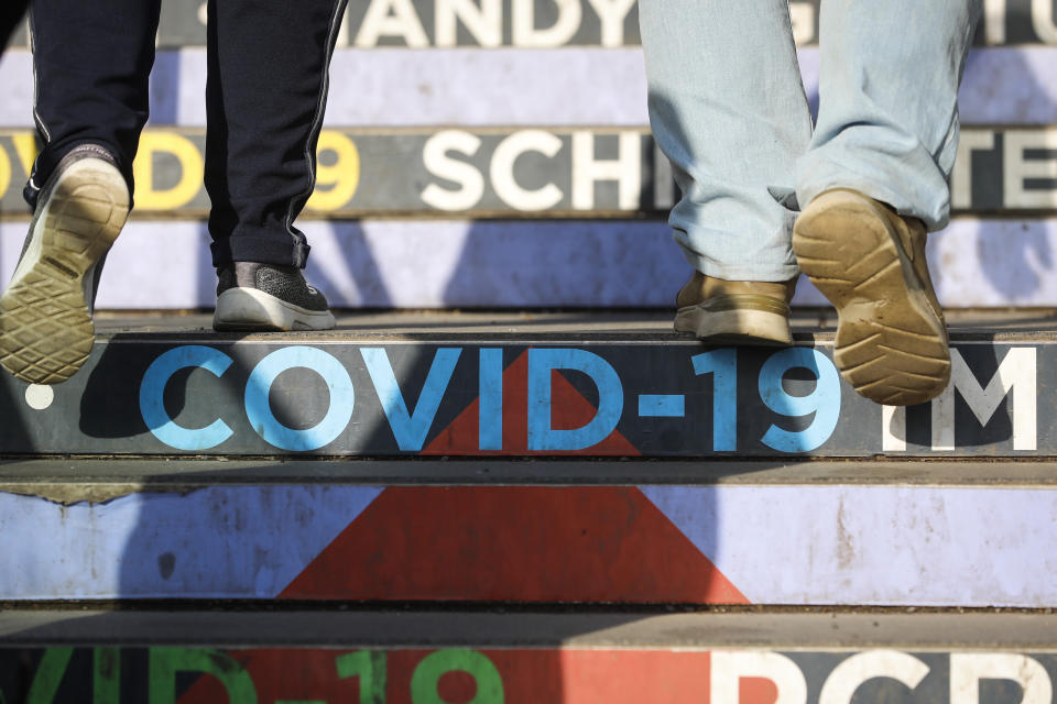 The compulsory COVID-19 vaccination starts in Vienna, Austria, Friday, Feb. 4, 2022. (AP Photo/Lisa Leutner)