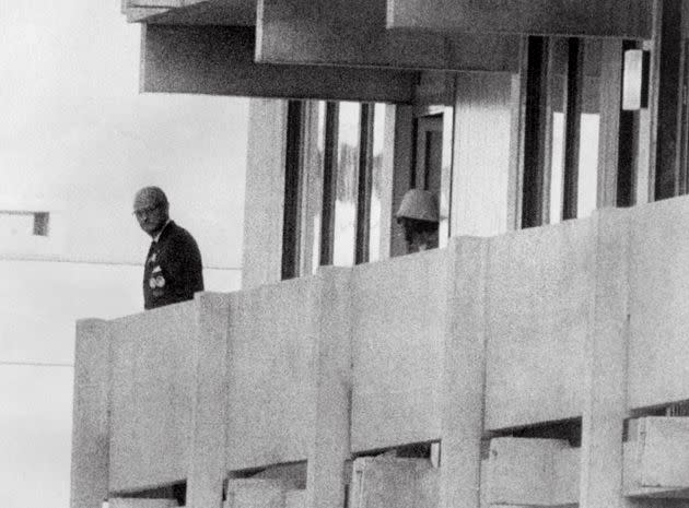 FILES - Picture taken on September 5, 1972 shows a Palestinian guerilla member (C) appearing on the balcony of the Israeli house watching an official (L) at the Munich Olympic village. As German magazine 