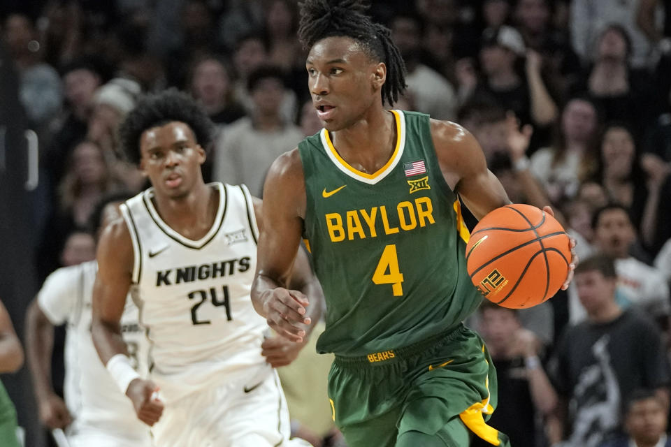 Baylor guard Ja'Kobe Walter (4) brings the ball downcourt past Central Florida guard Jaylin Sellers (24) during the first half of an NCAA college basketball game, Wednesday, Jan. 31, 2024, in Orlando, Fla. (AP Photo/John Raoux)