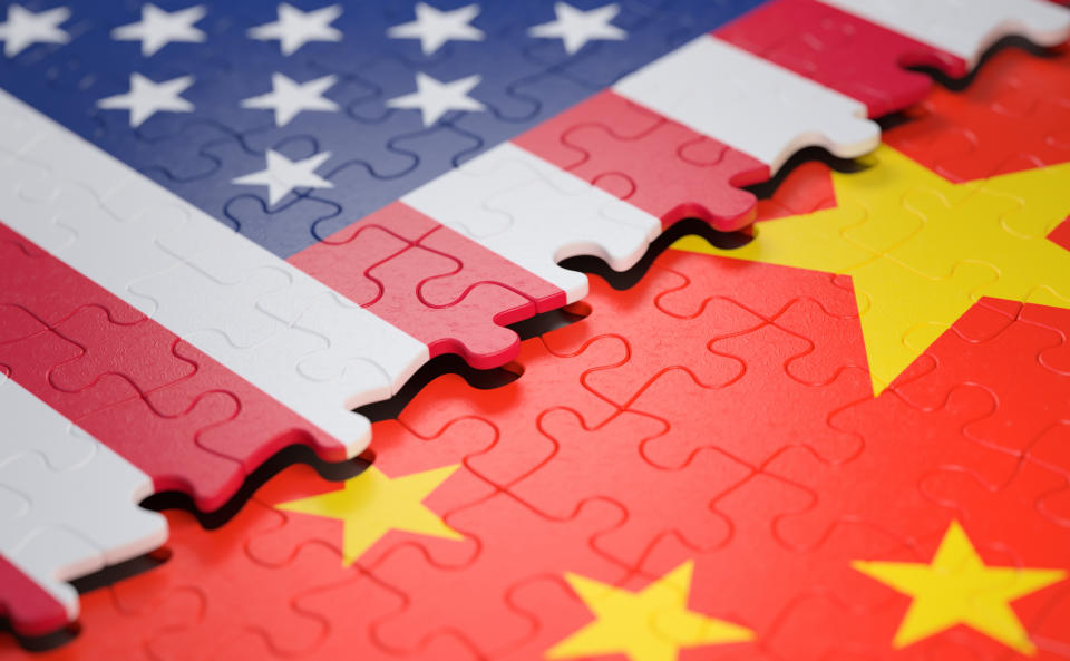 Overlapping jigsaw puzzles of the U.S. and Chinese flags.