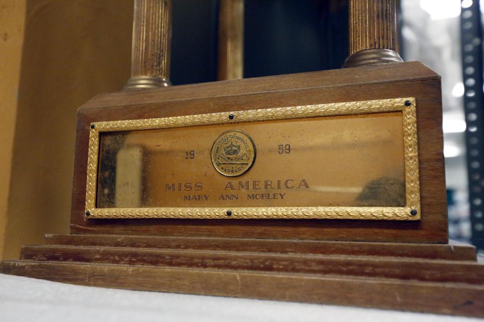 In this Oct. 11, 2013 photograph, the engraved plate of the trophy Mary Ann Mobley was awarded in 1959 when she was crowned Miss America, will eventually be displayed in the state history museum in Jackson, Miss. Officials say they did not set out to have separate-but-equal museums for the documentation of the state's history, but it could end up that way. Mississippi breaks ground Thursday. Oct. 24, 2013, on side-by-side museums that are expected to break ground of their own in how they depict the Southern state once rocked by racial turmoil. (AP Photo/Rogelio V. Solis)