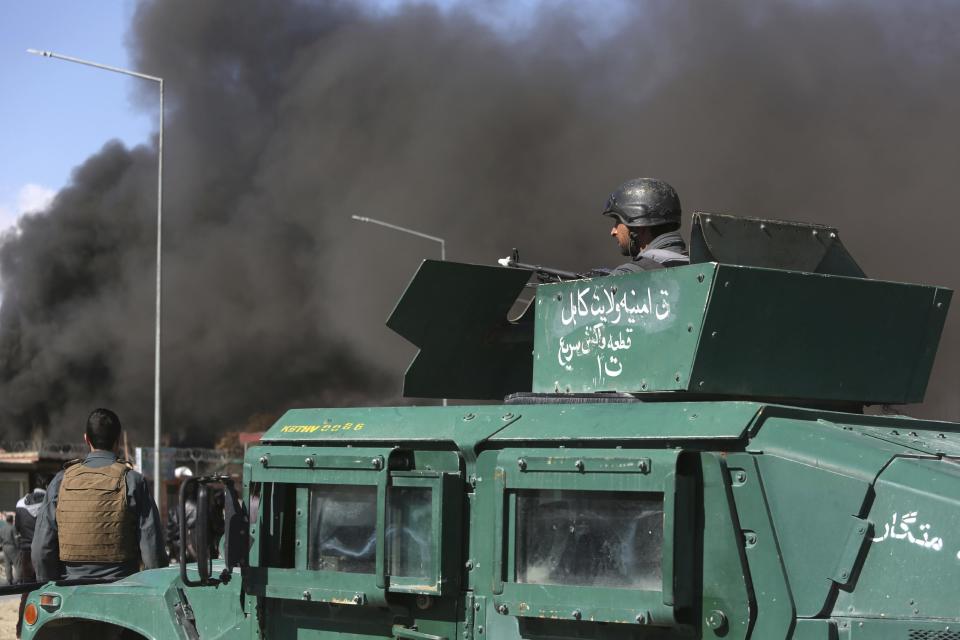 Smoke rises from a district police headquarters after a suicide bombing in Kabul, Afghanistan, Wednesday, March 1, 2017. A pair of suicide bombings, both claimed by the Taliban, struck the Afghan capital, an Afghan official said. (AP Photo/Rahmat Gul)