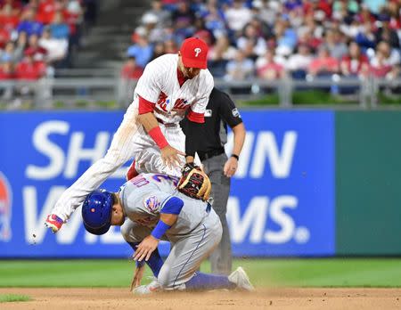 May 11, 2018; Philadelphia, PA, USA; Philadelphia Phillies second baseman Cesar Hernandez (16) braces himself after getting force out on New York Mets left fielder Michael Conforto (30) and throwing to first base to complete the double play at Citizens Bank Park. Mandatory Credit: Eric Hartline-USA TODAY Sports