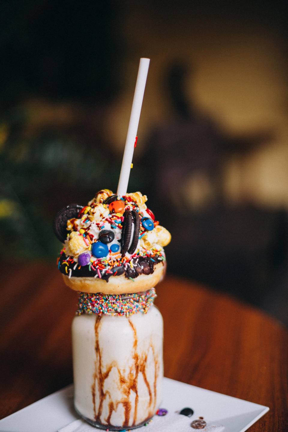 Chocolate donut milkshake with lots of toppings.