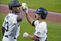 Pittsburgh Pirates' Adam Frazier, right, celebrates with Ke'Bryan Hayes on his way to the dugout after hitting a solo home run off Chicago Cubs starting pitcher Kyle Hendricks during the first inning of a baseball game in Pittsburgh, Wednesday, Sept. 23, 2020. Hayes followed Frazier with his own solo homer off Hendricks. (AP Photo/Gene J. Puskar)