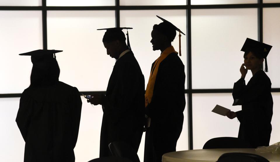 Graduates line up to have their official portraits taken at Shelton State before the spring commencement Friday, May 5, 2023.