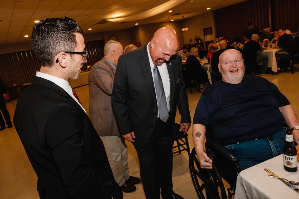 Robert Everett, center, shares a laugh Wednesday with national Fraternal Order of Police Vice President Joe Gamaldi, left, and David Archer, a former Dover police officer of 25 years, during the FOP Tuscora Lodge event honoring 50-year members.