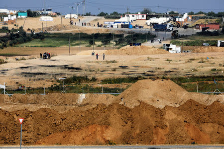 A general view shows the Israel-Gaza border, as Palestinians walk around the Gaza side of the border, Israel April 8, 2018. REUTERS/Amir Cohen