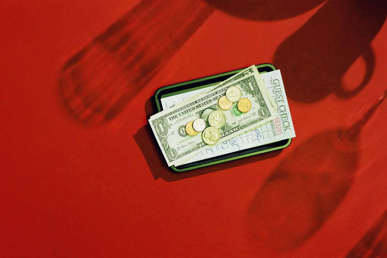 Restaurant bill and cash on small tray Getty Images/Paul Taylor