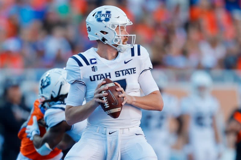 Utah State quarterback Spencer Petras (7) looks down field against Boise State in the first half of an NCAA college football game, Saturday, Oct. 5, 2024, in Boise, Idaho. . (AP Photo/Steve Conner) | Steve Conner