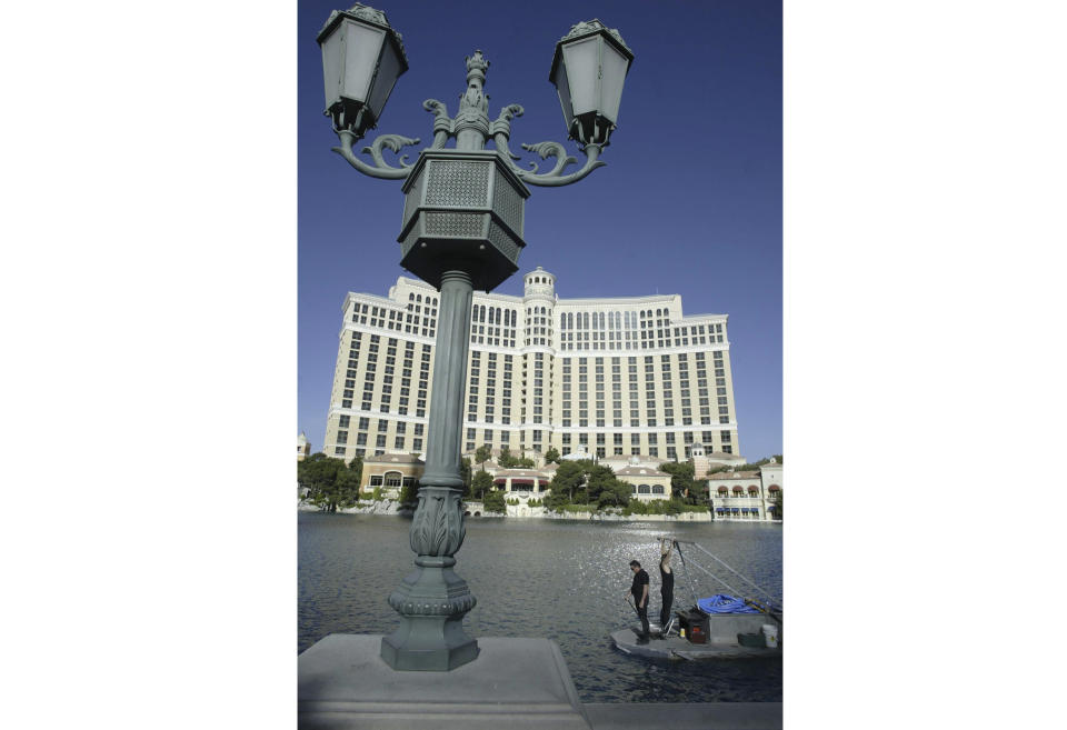 FILE - A crew cleans and tests the fountains at the Bellagio Casino and Hotel resort in Las Vegas, Nevada, on April 14, 2004. The Bellagio said in a social media post Tuesday, March 5, 2024 that it paused its fountains as it worked with state wildlife officials to rescue a yellow-billed loon who "found comfort on Las Vegas' own Lake Bellagio." (Matthew Minard/Las Vegas Sun via AP, file)