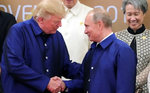 Donald Trump speaks with Vladimir Putin at the APEC Summit in Vietnam in November - Credit: Sputnik/Reuters