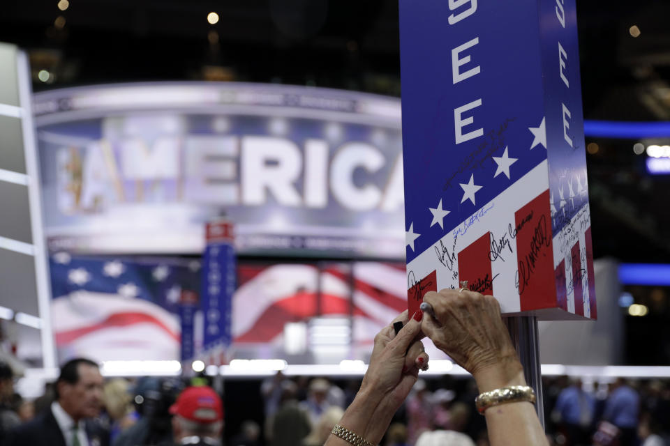 FILE - A Tennessee delegate signs on the post before the final day of the Republican National Convention in Cleveland, Thursday, July 21, 2016. Many state Republican parties made changes to their rules ahead of the 2020 election by adding more winner-take-all contests and requiring candidates to earn higher percentages of the vote to claim any delegates. (AP Photo/John Locher, File)