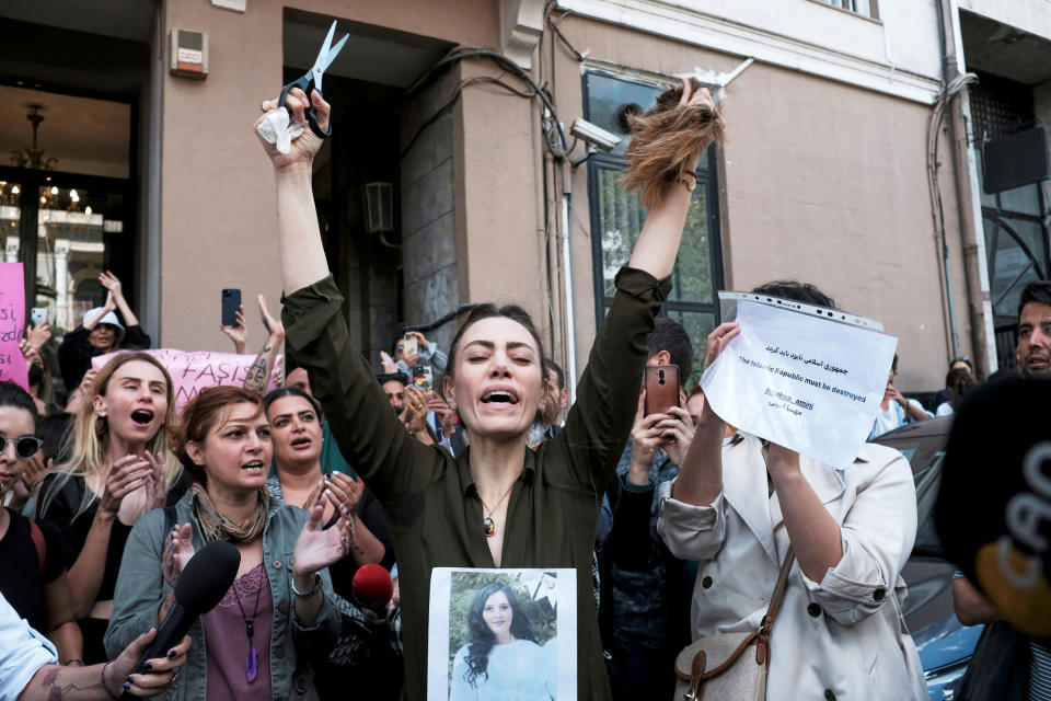 <b>Istanbul, Turkey</b> Nasibe Samsaei, an Iranian woman living in Turkey, reacts after she cut her hair during a protest outside the Iranian consulate in Istanbul, Turkey on Sept. 21, 2022.<span class="copyright">Murad Sezer—Reuters</span>