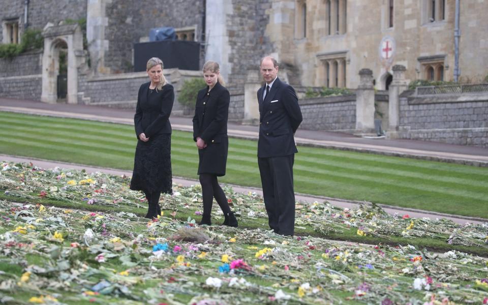 Edward, Sophie and Louise view flowers outside St George’s Chapel, Windsor, following the death of Prince Philip - AFP