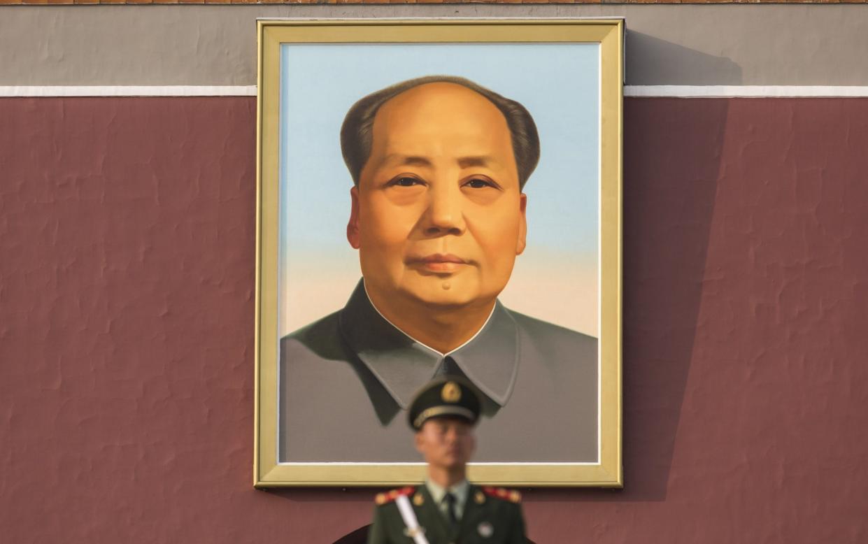 A soldier stands guard over a portrait of Mao Zedong at Tiananmen Square in Beijing - Qilai Shen