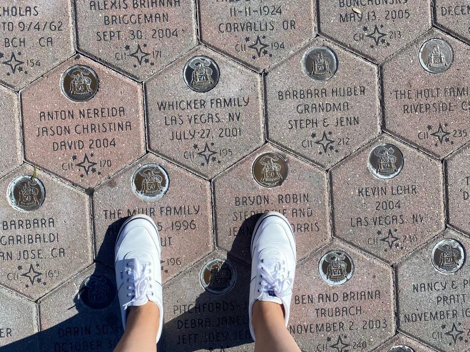 pair of sneakers on a set of embossed bricks at disneyland