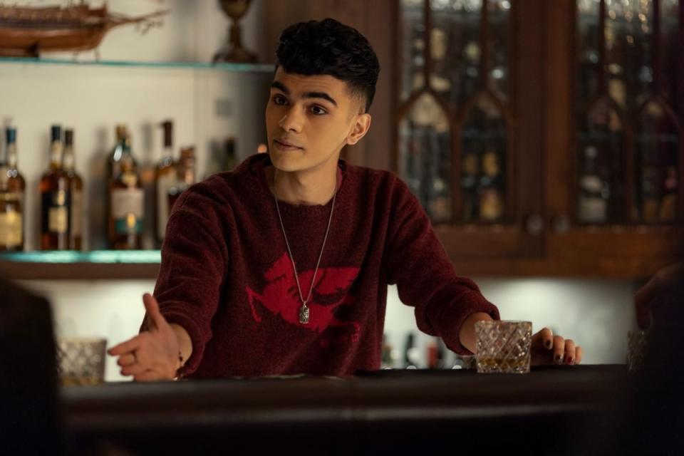 A young man in a red shit behind a bar in The Fall Of The House Of Usher