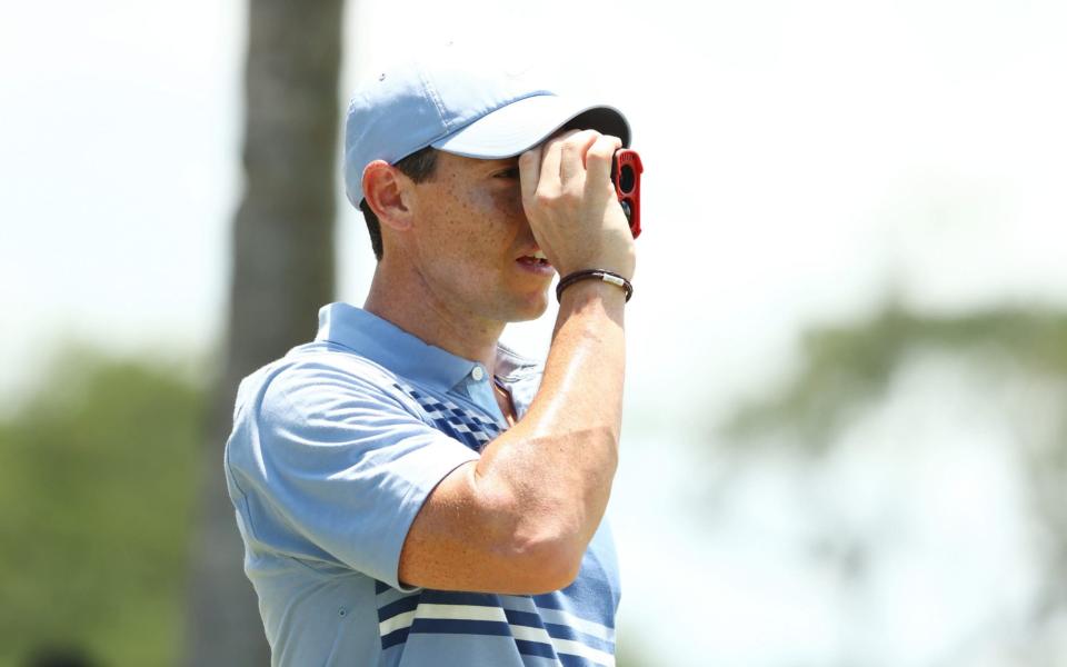 Rory McIlroy of the American Nurses Foundation team uses a rangefinder in practice - Mike Ehrmann/Getty Images