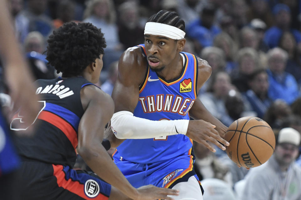 Oklahoma City Thunder guard Shai Gilgeous-Alexander, right, tries to push past Detroit Pistons forward Ausar Thompson, in the first half of an NBA basketball game, Monday, Oct. 30, 2023, in Oklahoma City. (AP Photo/Kyle Phillips)