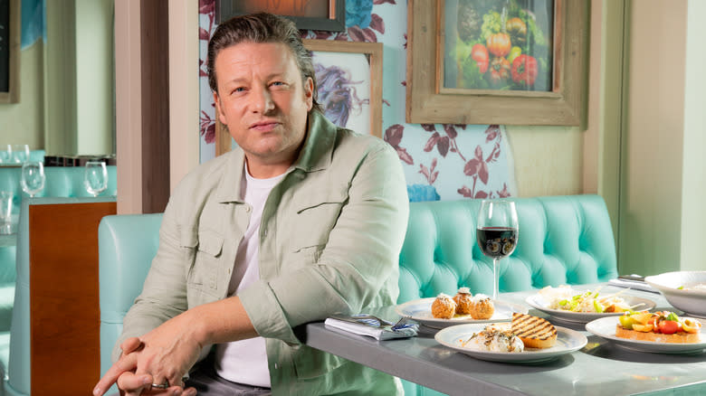 Jamie Oliver sitting with food