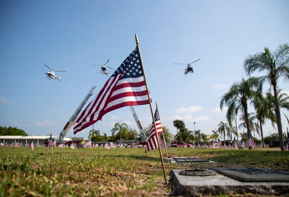 Helicopter pilots perfrom a flyover during a Memorial Day ceremony at Coral Ridge Funeral Home & Cemetery on Monday, May 31, 2021, in Cape Coral.