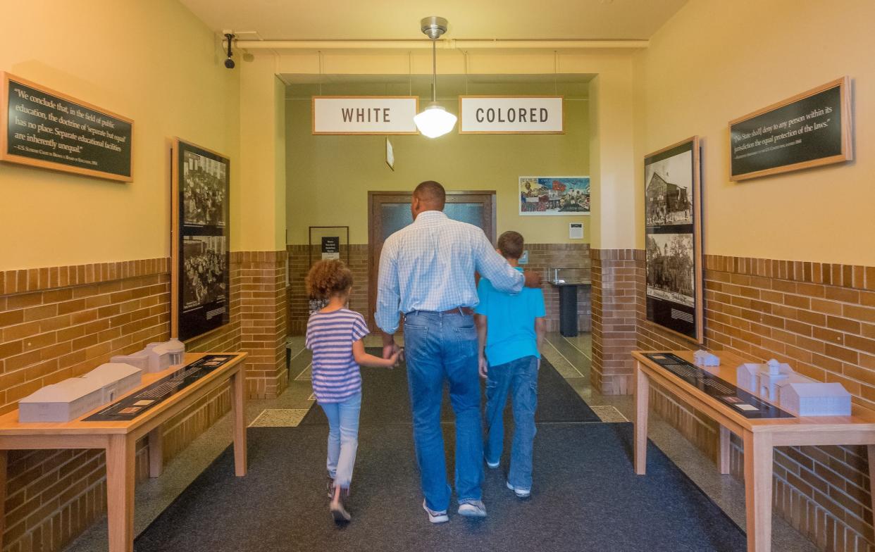 Visitors walk through the Brown v. Board of Education Hallway.