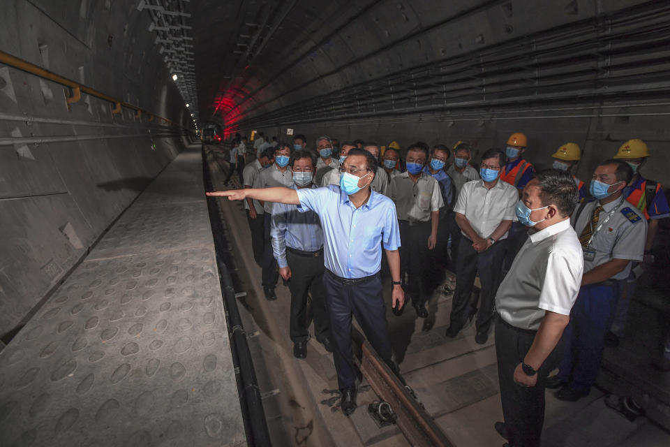 FILE - In this photo released by Xinhua News Agency, Chinese Premier Li Keqiang, front left, wearing a face mask, visits the tunnel of subway line 5 in Zhengzhou city in central China's Henan province, on Aug. 18, 2021. Former Premier Li Keqiang, China's top economic official for a decade, died Friday, Oct. 27, 2023 of a heart attack. He was 68. (Rao Aimin/Xinhua via AP, File)